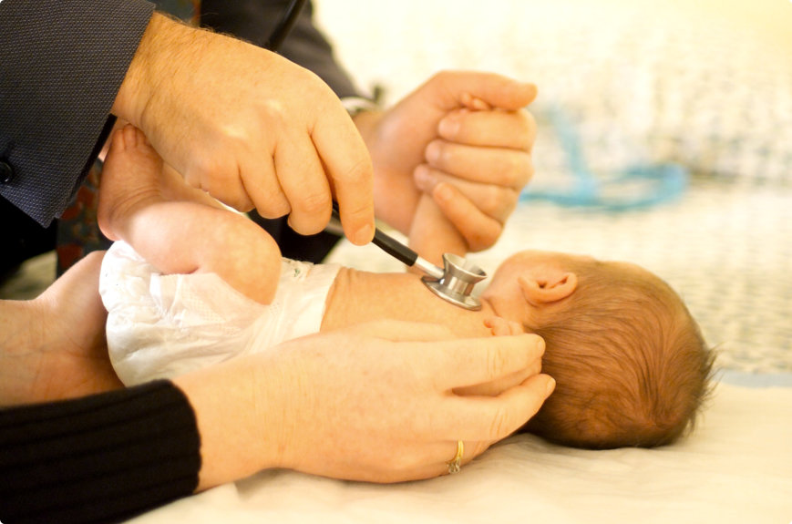 medical staff checking baby using stethoscope