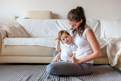 small boy playing with his mother in the living room