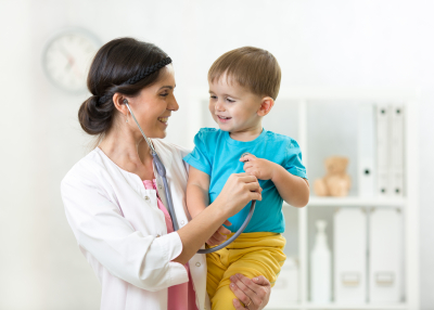 doctor examining little boy with stethoscope