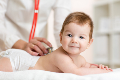 pediatrician listens to baby heartbeat with stethoscope